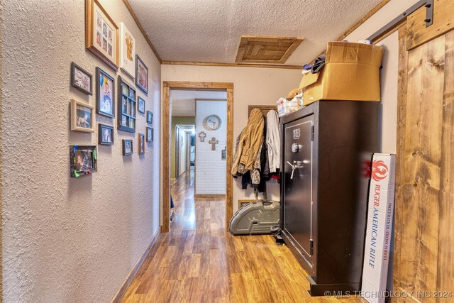 8248 E 122nd Rd, Wetumka, OK 74883 - hallway with a textured ceiling, a textured wall, wood finished floors, and baseboards