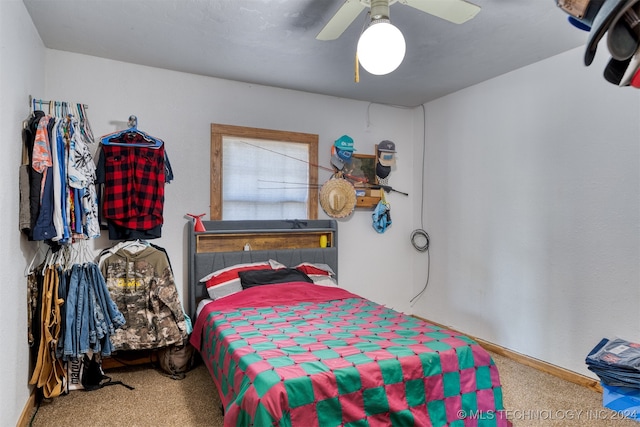 bedroom featuring ceiling fan and carpet