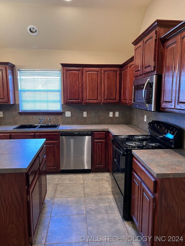 kitchen with sink, tasteful backsplash, appliances with stainless steel finishes, and light tile patterned floors