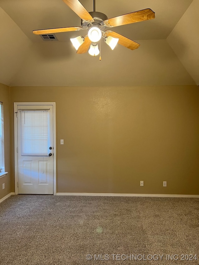 unfurnished room featuring ceiling fan, carpet flooring, and vaulted ceiling