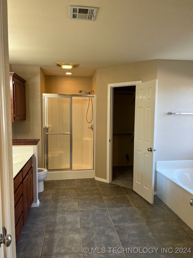 full bathroom with plus walk in shower, toilet, vanity, and tile patterned floors