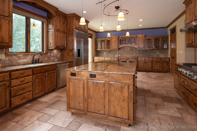 kitchen featuring hanging light fixtures, sink, an island with sink, and stainless steel appliances