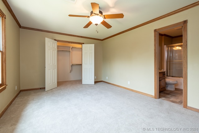 unfurnished bedroom with a closet, ceiling fan, crown molding, and light carpet