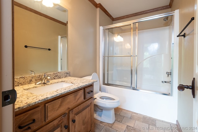 full bathroom featuring vanity, enclosed tub / shower combo, crown molding, and toilet