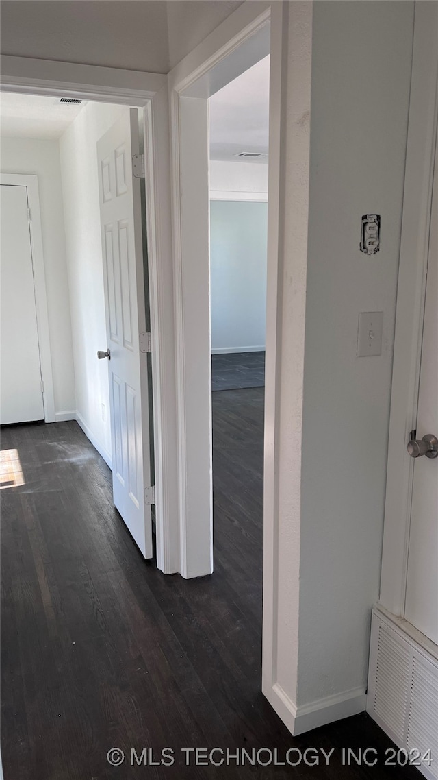 hallway with hardwood / wood-style floors