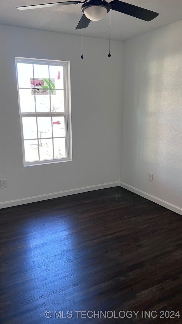 spare room with ceiling fan and wood-type flooring