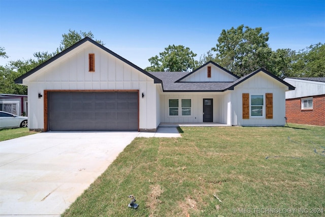 modern farmhouse style home featuring a garage, concrete driveway, a front lawn, and roof with shingles