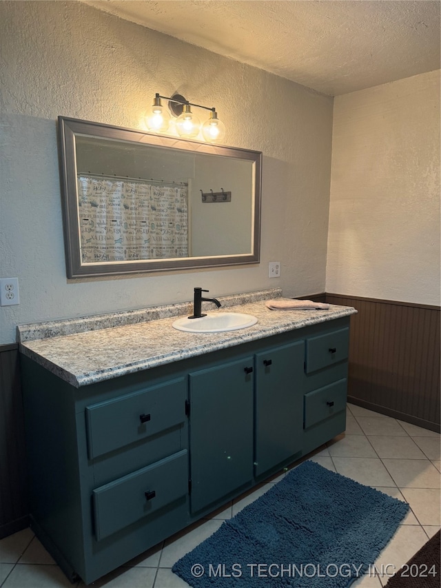 bathroom featuring vanity, tile patterned flooring, and a textured ceiling