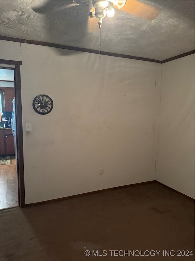 unfurnished room featuring ceiling fan and a textured ceiling