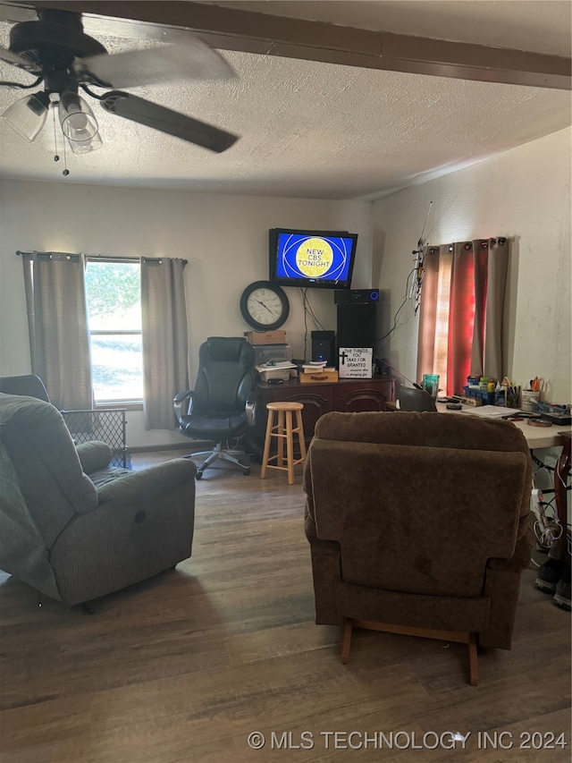 living room with ceiling fan, hardwood / wood-style flooring, and a textured ceiling