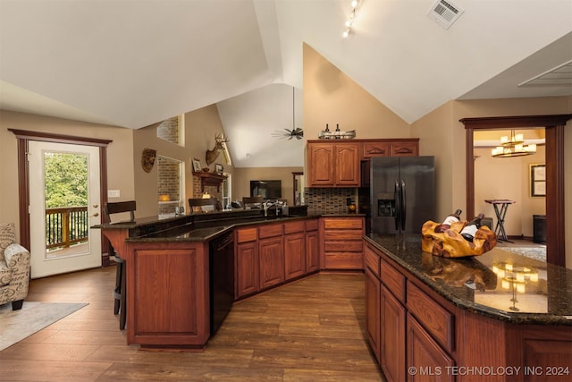 kitchen with a breakfast bar, dishwasher, dark hardwood / wood-style flooring, stainless steel fridge with ice dispenser, and kitchen peninsula