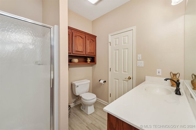 bathroom with vanity, toilet, and walk in shower