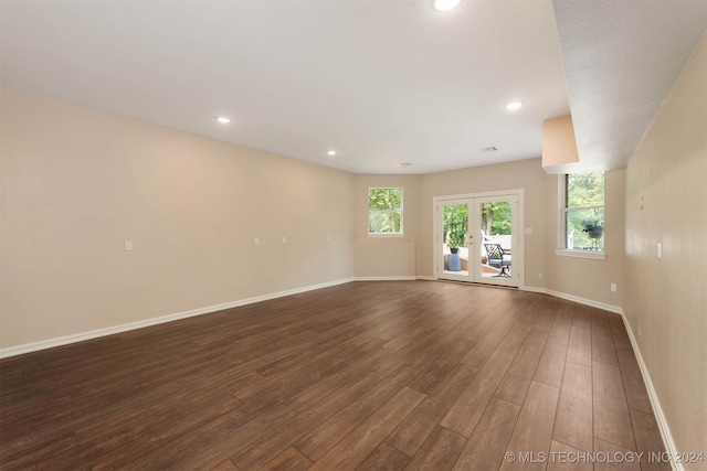 unfurnished room featuring dark hardwood / wood-style floors and french doors