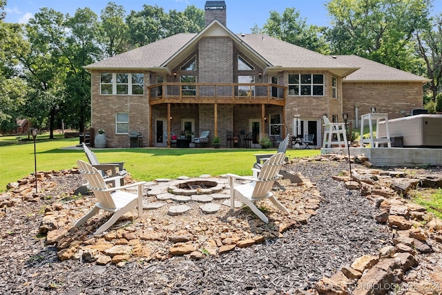 back of house featuring an outdoor fire pit, a yard, and a patio