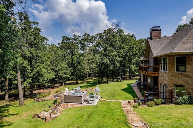 view of yard featuring a hot tub and a patio