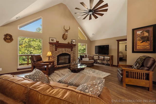 living room with hardwood / wood-style floors, high vaulted ceiling, and a healthy amount of sunlight