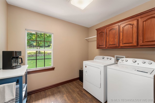 washroom featuring dark hardwood / wood-style flooring, cabinets, and washing machine and clothes dryer