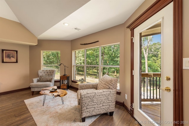 living room with vaulted ceiling and dark hardwood / wood-style floors