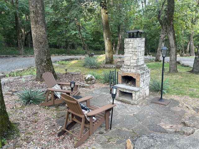 view of patio featuring an outdoor stone fireplace