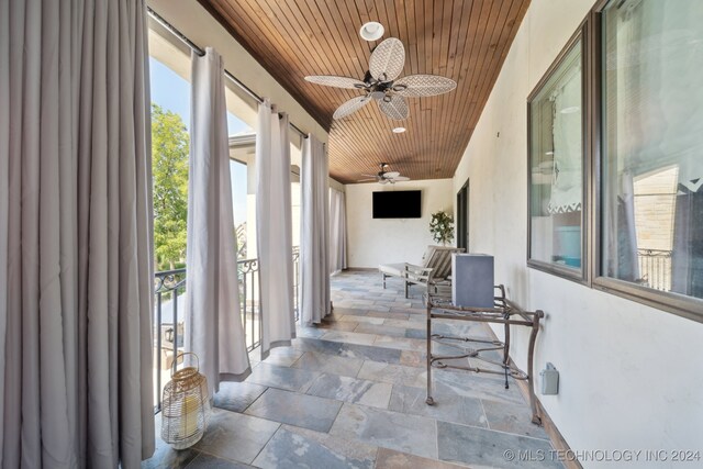 sunroom featuring ceiling fan, a healthy amount of sunlight, and wood ceiling