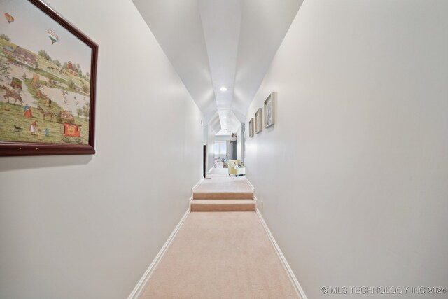 hallway featuring light colored carpet