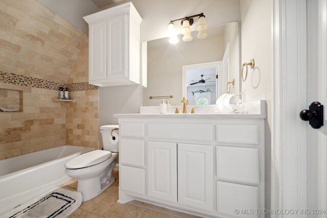 full bathroom with ceiling fan, toilet, tile patterned flooring, vanity, and tiled shower / bath