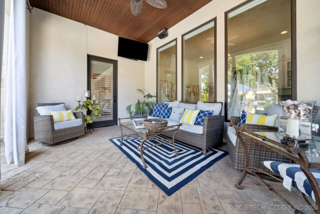 view of patio with an outdoor living space and ceiling fan