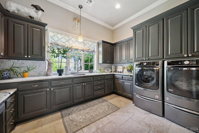 washroom featuring cabinets, washer and clothes dryer, sink, crown molding, and light tile patterned flooring