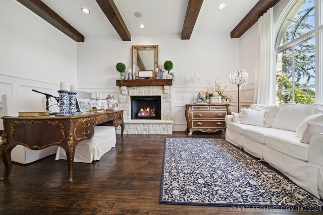 living room with beam ceiling, a stone fireplace, and wood-type flooring