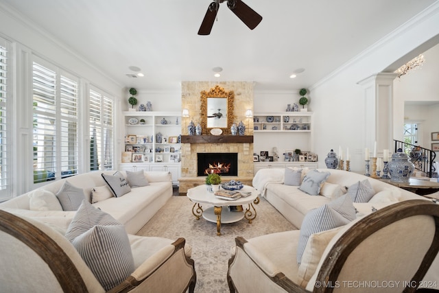 living room featuring a fireplace, ceiling fan, a healthy amount of sunlight, and built in shelves