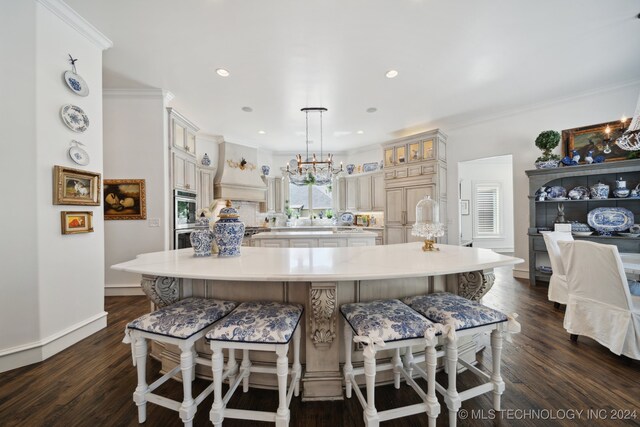 kitchen with a spacious island, custom range hood, and dark hardwood / wood-style flooring