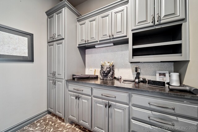 kitchen with gray cabinetry and backsplash