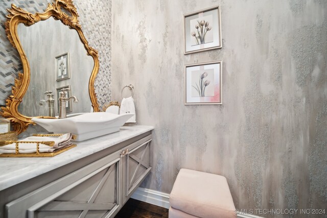 bathroom with toilet, vanity, and hardwood / wood-style flooring