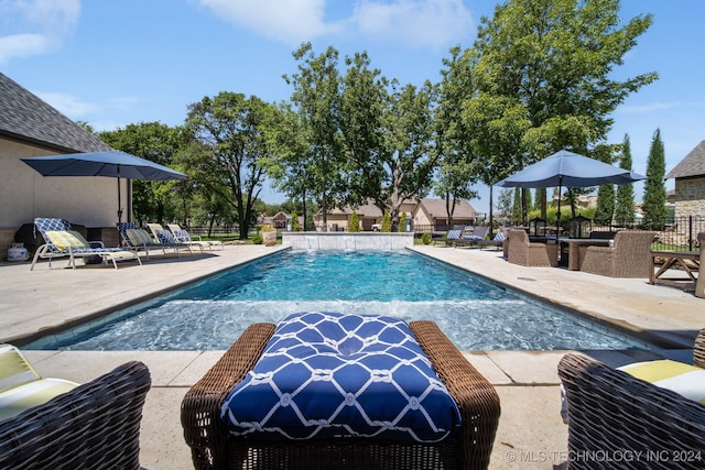 view of swimming pool with a patio