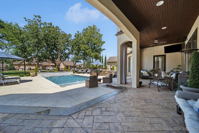 view of pool featuring ceiling fan and a patio area