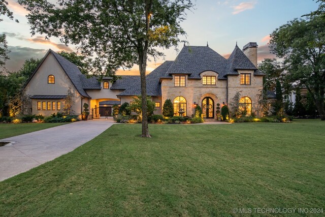 french country home with a yard