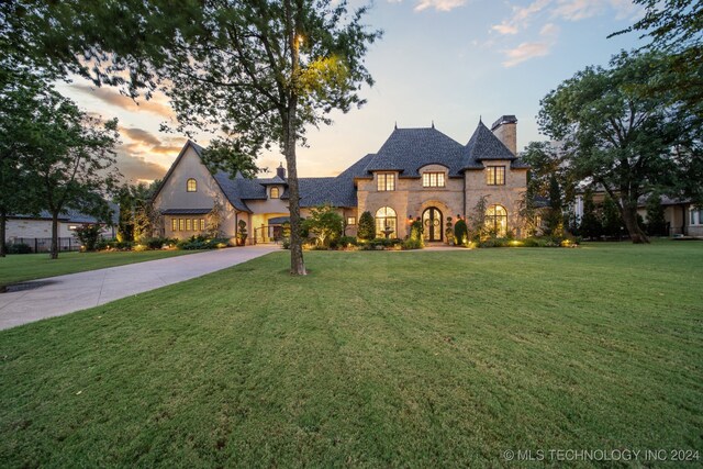 french country style house featuring a yard