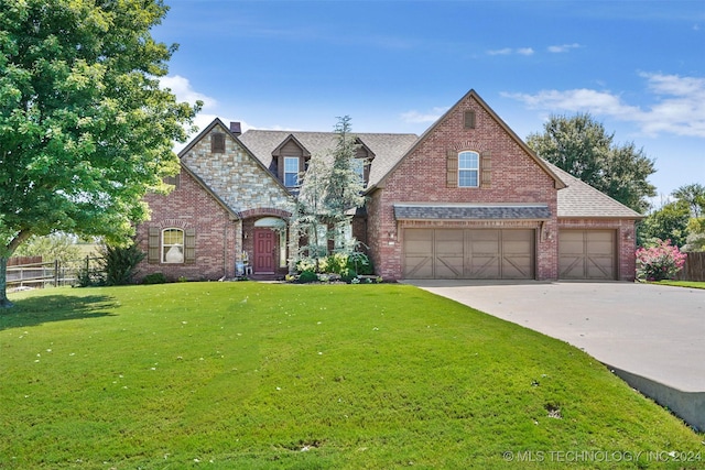 view of front of home featuring a garage and a front lawn