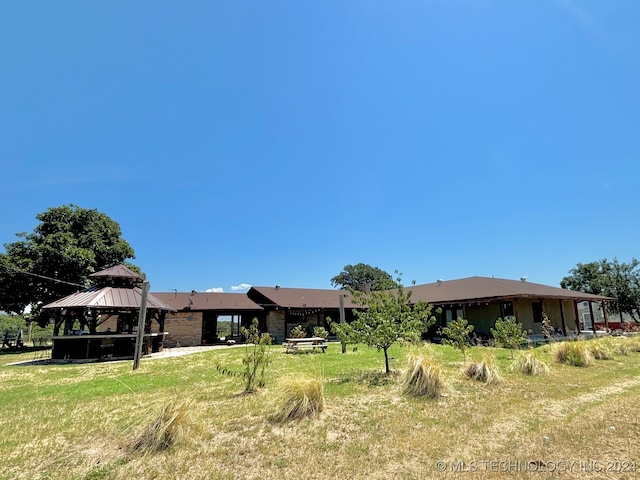 rear view of property with a gazebo