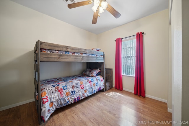 bedroom with ceiling fan and wood-type flooring