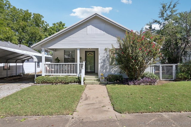 bungalow-style house featuring a front yard, a carport, and a porch