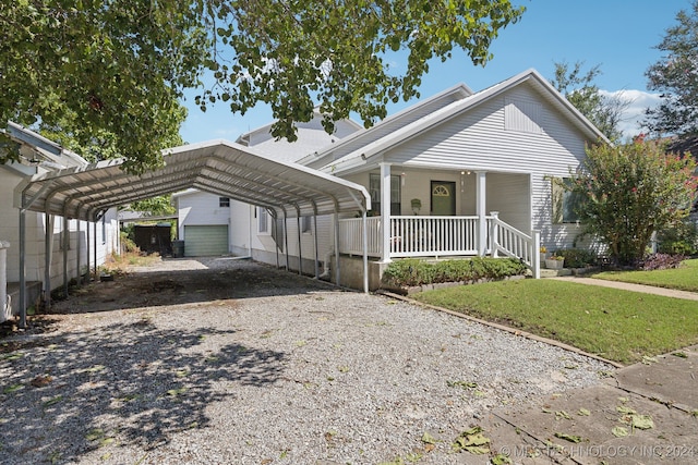 view of front of property featuring a front yard, a carport, and covered porch