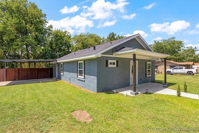 view of property exterior with a carport and a lawn