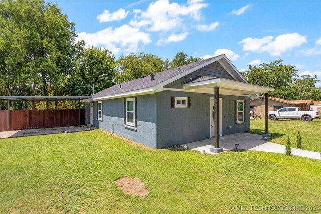 701 W Alabama, Durant, OK 74701 - view of property exterior featuring fence, a yard, and a patio