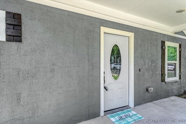 701 W Alabama, Durant, OK 74701 - doorway to property featuring stucco siding