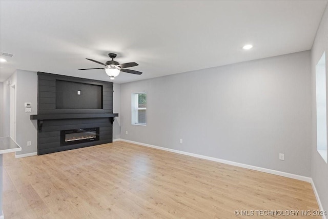 701 W Alabama, Durant, OK 74701 - unfurnished living room with visible vents, baseboards, wood finished floors, ceiling fan, and a fireplace