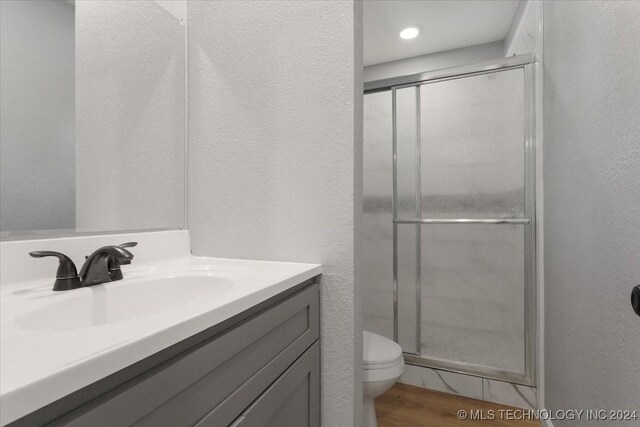 701 W Alabama, Durant, OK 74701 - bathroom featuring a textured wall, vanity, toilet, and a stall shower