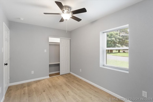 unfurnished bedroom with a closet, ceiling fan, and light wood-type flooring