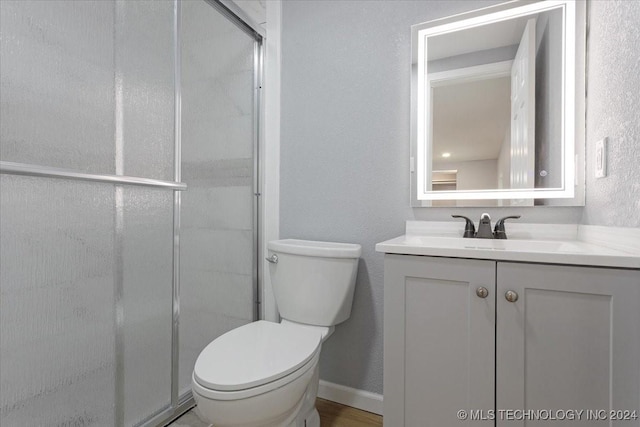 701 W Alabama, Durant, OK 74701 - bathroom featuring a stall shower, vanity, and toilet
