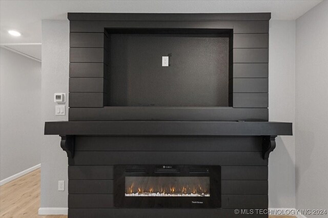 701 W Alabama, Durant, OK 74701 - details featuring wood finished floors, baseboards, and a lit fireplace